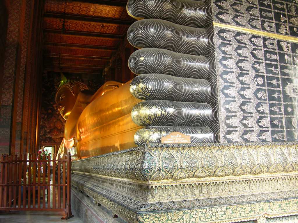 Bangkok 03 01 Wat Po Temple of the Reclining Buddha Also known as the Temple of the Reclining Buddha, Wat Po was built by Rama I in the 16C and is the oldest and largest Buddhist temple in Bangkok. The enormous Reclining Buddha is 46m long and 15m high, with each foot 3m high and 5m long. The statue is brick, covered with layers of plaster, and gold leaf. The most striking part of the statue is its soles, which are decorated with 108 auspicious patterns inlaid with mother-of-pearl.